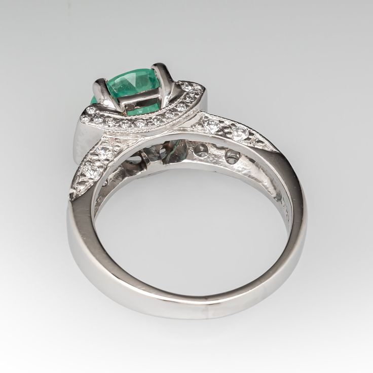 This glamorous ring is centered with one (1) round cut Seafoam tourmaline in a four-prong setting. The ring is accented with two (2) bezel set baguette cut diamonds, and forty-two (42) bead set round brilliant cut diamonds. The ring measures 7.8mm at the top, rises 8.2mm above the finger, tapering to 3.1mm wide and 1.4mm thick at the base of the shank. It is currently a size 7.25. Luxury Emerald Ring With Prong Setting, Fine Jewelry Emerald Ring With Accent Stones, Emerald Ring With Accent Stones For May Birthstone, Luxury Round Diamond Ring For May Birthstone, Modern Emerald Jewelry With Center Stone, Emerald Ring With Cubic Zirconia And Accent Stones, Elegant Green Topaz Ring With Round Cut, Emerald Promise Ring With Center Stone, Elegant Green Round Cut Topaz Ring