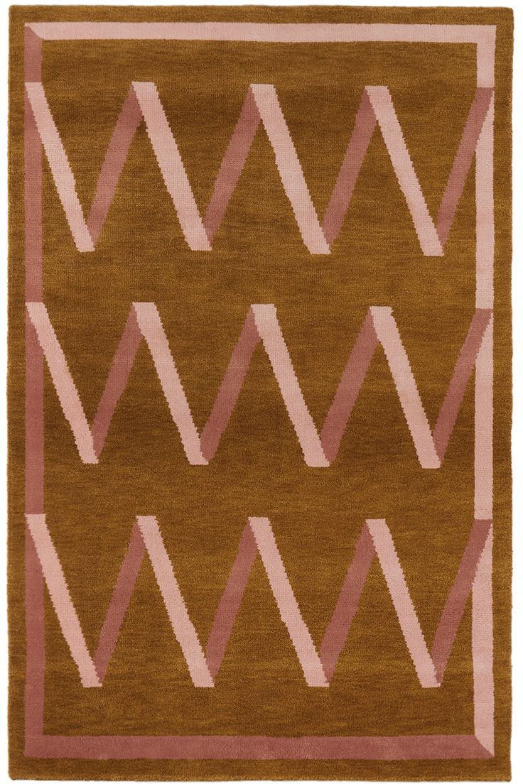 a brown rug with pink and white designs on it's sides, in the shape of zigzag