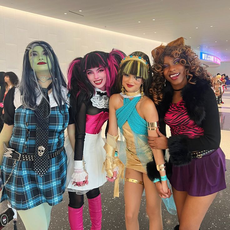 three women dressed in costumes standing next to each other