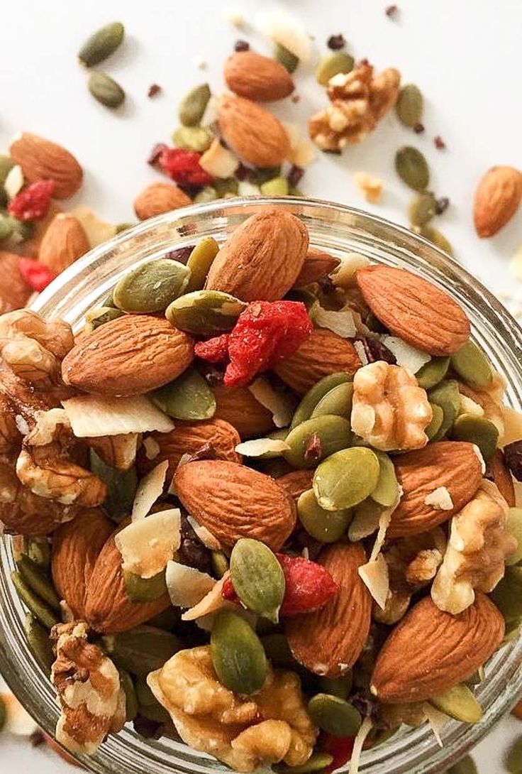 a glass jar filled with nuts and seeds