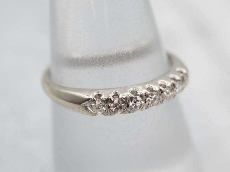 This elegant white gold diamond wedding band is the perfect way to show your everlasting love. With 7 carefully set diamonds, it sparkles with eternal promise. Enjoy a lifetime of romance with this stunning band.Metal: 14K White GoldGem: 7 Diamonds totaling .27 Carats, VS-SI in Clarity, H-J in ColorWidth of Band: 3.2 mmHeight off Finger: 2.4 mmRing Size: 6.50Marks: "14K" Stamped on the inside band Diamond Ring With Diamond Accents For Wedding, Wedding Eternity Band With Prong Setting, Formal Silver Eternity Band With Prong Setting, Wedding Diamond Ring With Round Band And Diamond Accents, Silver Eternity Band With Prong Setting For Formal Occasions, Wedding Diamond Ring With Round Band And Accents, Silver Half Eternity Diamond Ring For Marriage, Half Eternity Diamond Ring For Marriage, Diamond White Eternity Band With Diamond Accents For Wedding