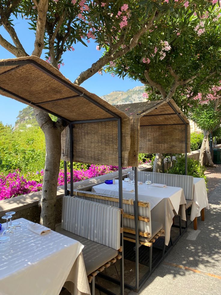 an outdoor dining area with tables and umbrellas