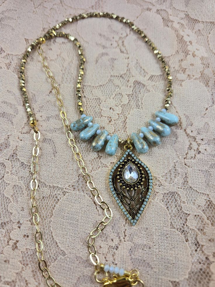 This elegant statement necklace makes a nice gift for a birthday, anniversary, the holidays or for any special occasion or for a night out on the town! It can be worn all year round. It is designed with pale turquoise and gold glass teardrop beads, gold shiny metal beads, a 14kt gold plated chain and lobster claw clasp, and a color coordinated pale turquoise, crystal and gold plated teardrop pendant. The drop length is 14 inches.  If you look through my earring and bracelet collection you should Gold Beaded Dangle Necklaces For Party, Party Necklace With Jeweled Teardrop, Teardrop Jeweled Party Necklaces, Party Teardrop Jeweled Necklaces, Party Teardrop Jeweled Necklace, Gold Beaded Turquoise Pendant Necklace, Gold Beaded Dangle Drop Necklace, Gold Crystal Necklace With Dangling Beads For Gifts, Turquoise Jeweled Necklace For Party