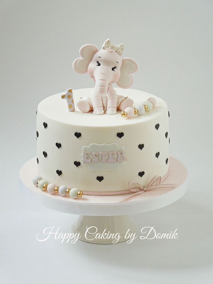 a white cake with black hearts and an elephant on top