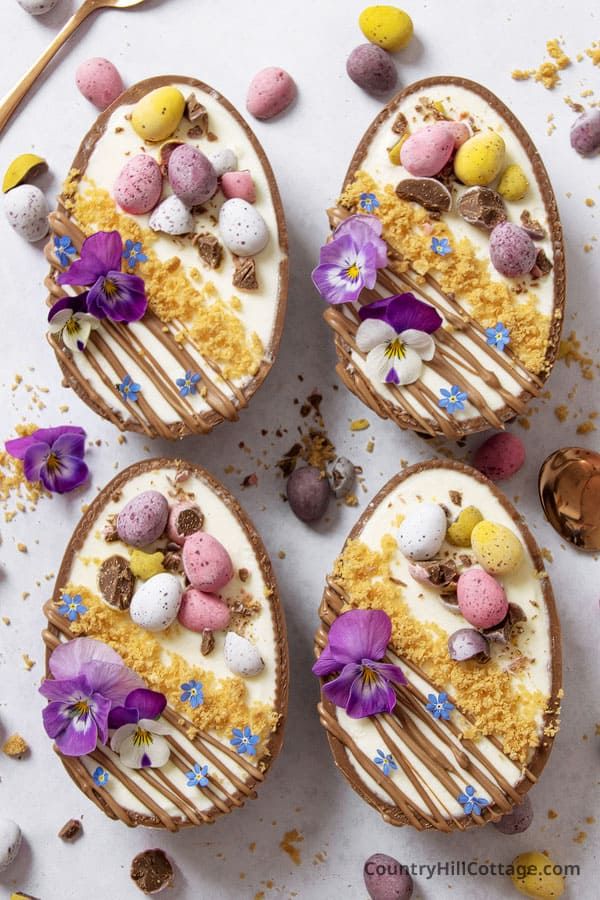 three desserts with chocolate, marshmallows and flowers on them are arranged in the shape of eggs