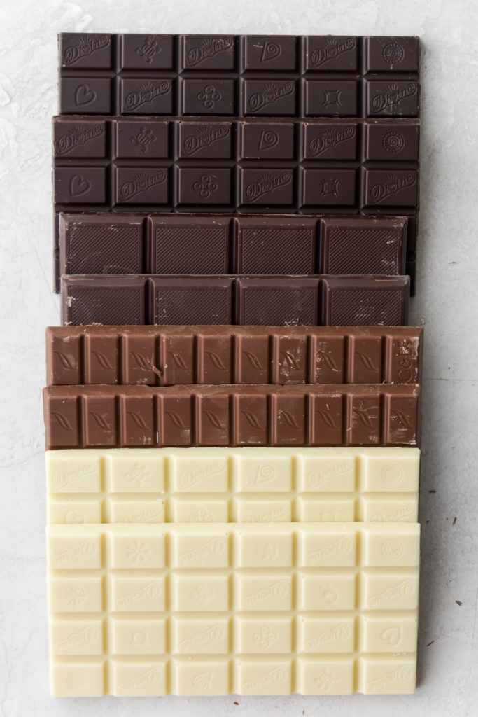 three chocolate bars stacked on top of each other in different colors and sizes, with one bar missing