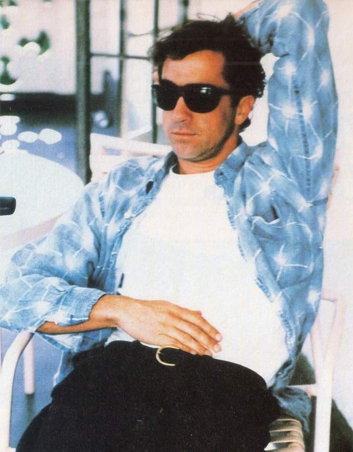 a man sitting in a chair wearing sunglasses