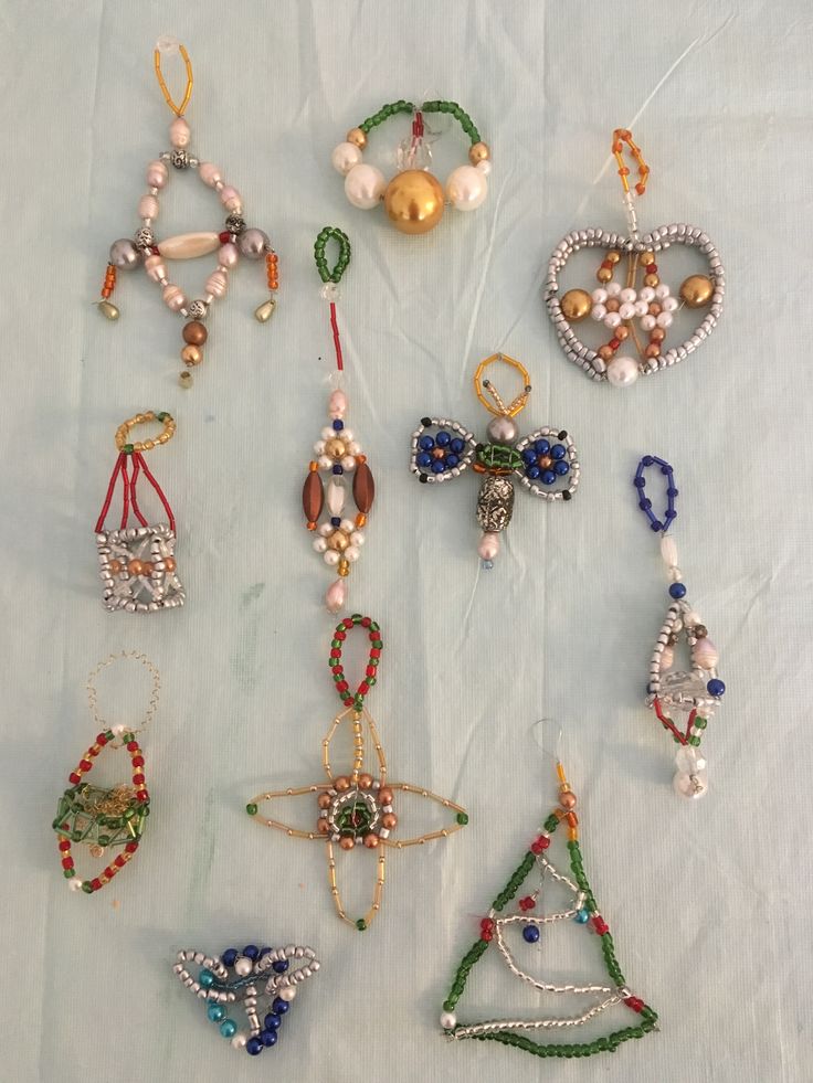 many different types of beaded jewelry on a white sheet