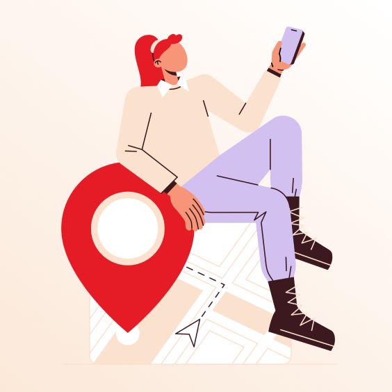 a woman sitting on top of a map holding a cell phone and looking at it