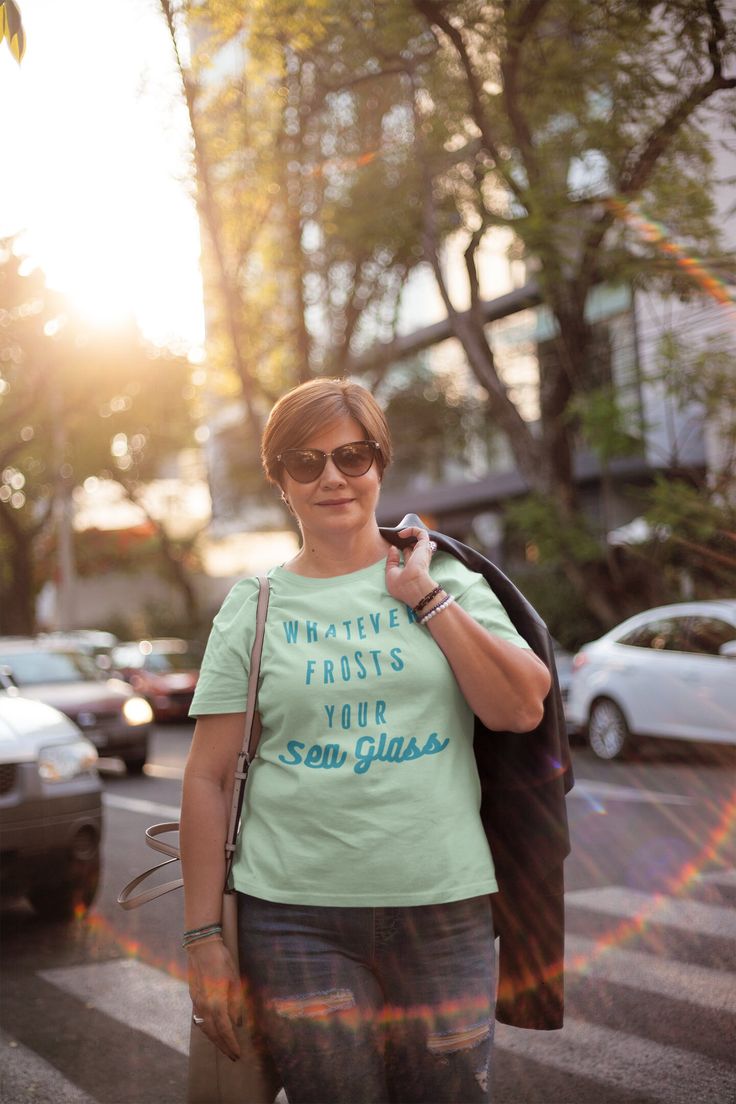 "Get ready to show off your love for sea glass with this hilarious and stylish t-shirt! Featuring the phrase \"Whatever Frosts Your Sea Glass\" in a fun, whimsical font, this shirt is perfect for any beachcomber, sea glass enthusiast, or anyone who loves a good pun. Made with high-quality Bella Canvas 3001 t-shirts, this shirt is both comfortable and durable. The shirt comes in a range of sizes, from small to 3XL, and is available in several different colors to suit your style. This sea glass shirt makes a great gift for anyone who loves spending time at the beach, collecting sea glass, or just appreciates a good joke. It's perfect for wearing to the beach, on a boat trip, or just out and about on a sunny day. Features: High-quality Bella Canvas 3001 t-shirt \"Whatever Frosts Your Sea Glas Iphone Laptop, Middle Aged Woman, Funny Beach, Volleyball Mom Shirts, Middle Aged Women, Religious Shirt, Mockups Design, Christian T Shirt, Clothing Mockup