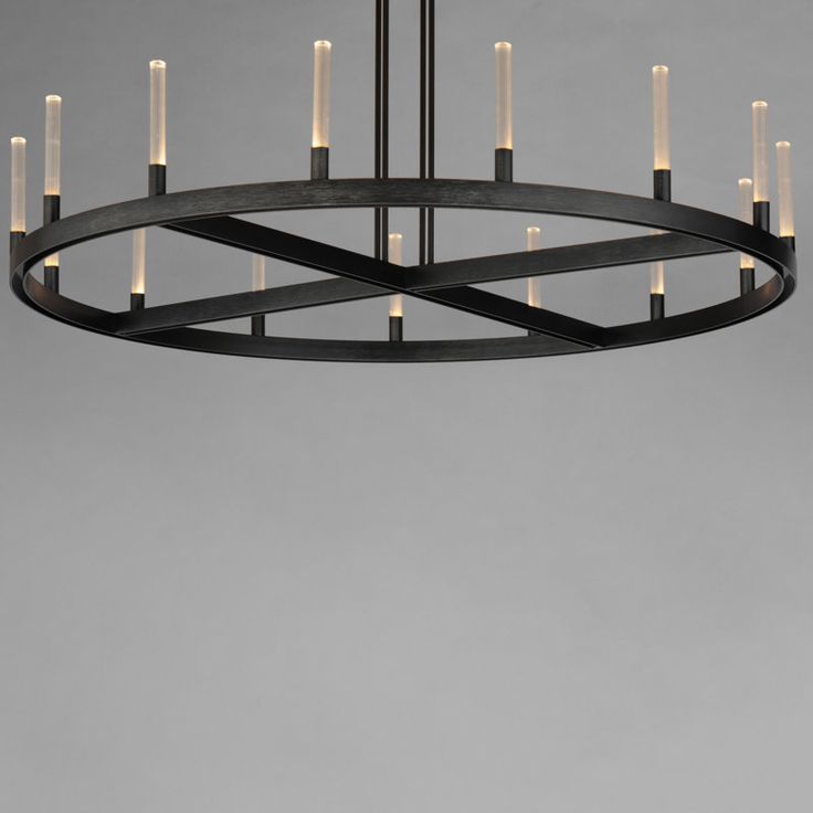 a circular chandelier with eight candles hanging from the center, in an industrial style