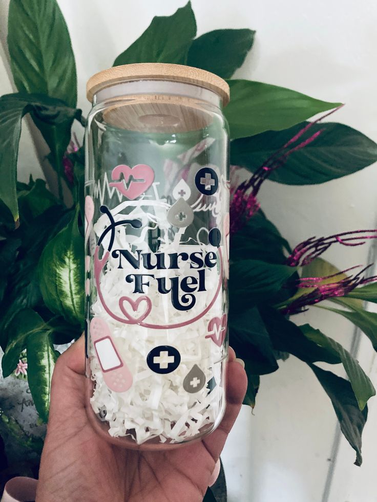 a person holding up a glass jar filled with white rice and other things in it