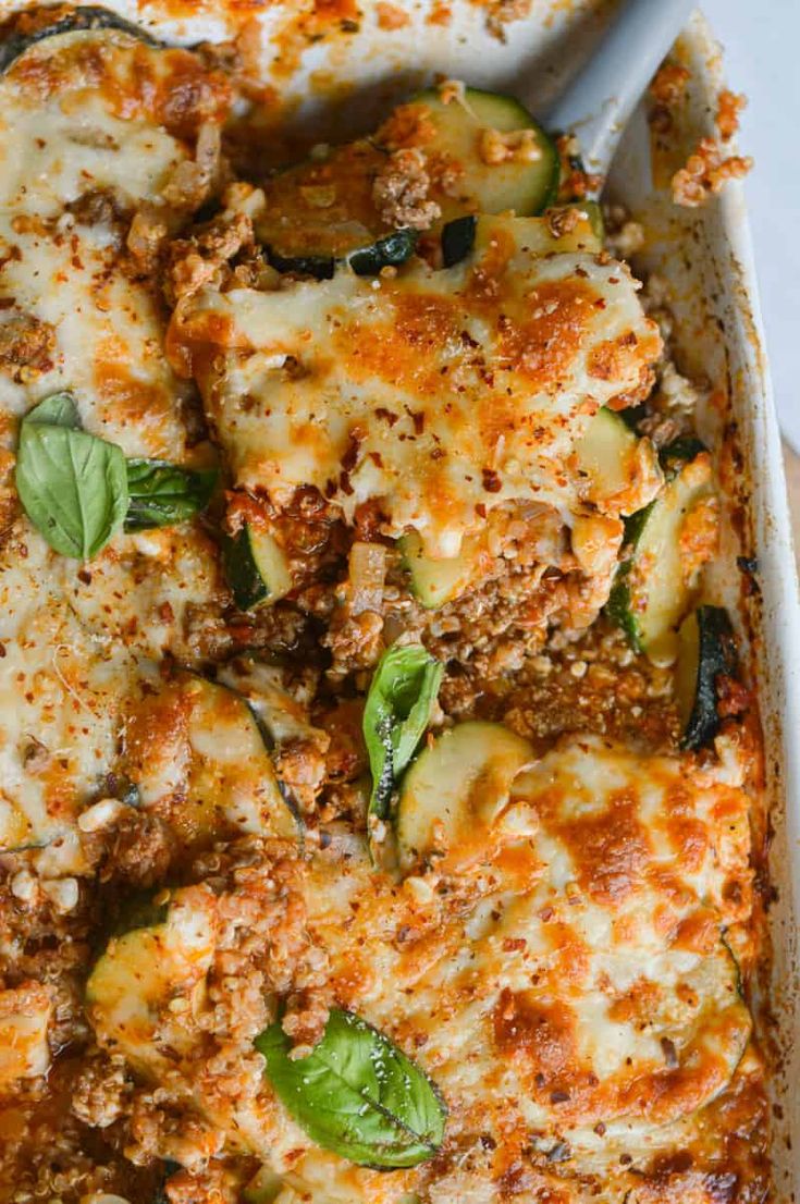 a casserole dish with zucchini and cheese