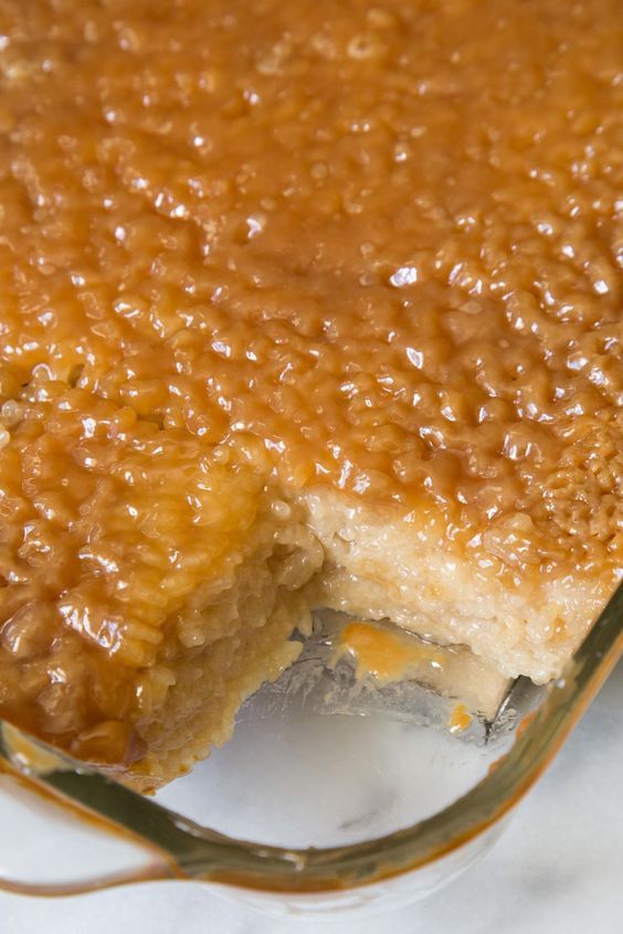 a piece of cake with caramel sauce on it sitting on top of a plate