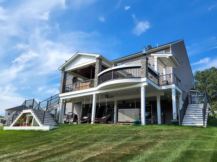 a large house with several balconies on the upper level