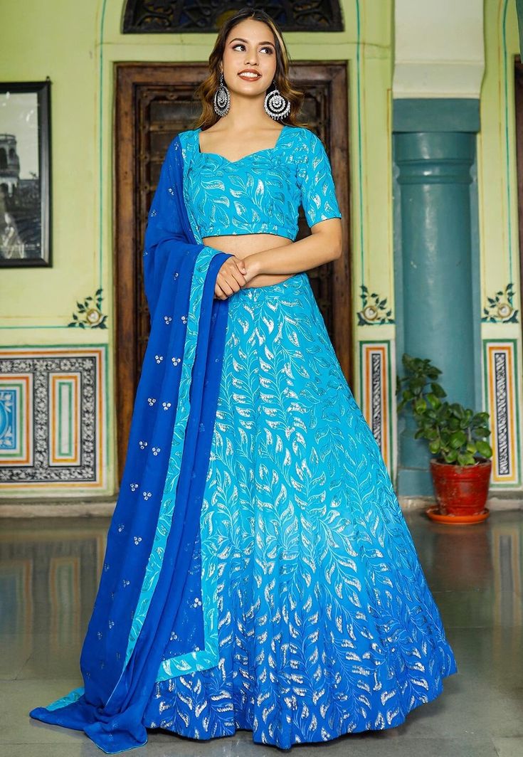 Readymade Faux Georgette Lehenga in Shaded Blue. This attire with Shantoon and Cotton Lining is Enhanced with Fancy Tassels, Resham and Sequins WorkAvailable with a Faux Georgette Blue Choli Crafted in Sweetheart Neck and Half Sleeves and a Faux Georgette Dupatta in Royal Blue. The Choli and Lehenga Lengths are 14 and 42 inches respectively. Do Note: Accessories shown in the image are for presentation purposes only. (Slight variation in actual color vs. image is possible). We sell all kinds of L Festive Blue Semi-stitched Sharara, Festive Semi-stitched Blue Sharara, Blue Semi-stitched Traditional Wear With Sequins, Blue Sequined Sets For Festive Occasions, Blue Saree Sets With Sequins, Blue Sharara For Navratri Reception, Blue Sequined Saree Traditional Wear, Blue Sequined Traditional Wear With Drape, Traditional Blue Sequin Choli