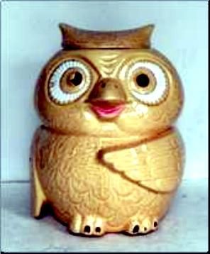 an owl figurine with big eyes and a hat on its head, sitting in front of a white background