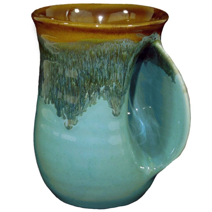 a blue and brown vase with water flowing down it's side, on a white background