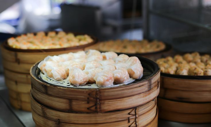 some food is sitting in bamboo baskets on a table