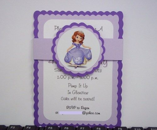 a purple and white birthday card with a princess on it's back, in front of a keyboard