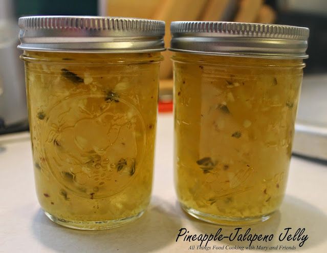 two jars filled with food sitting on top of a counter