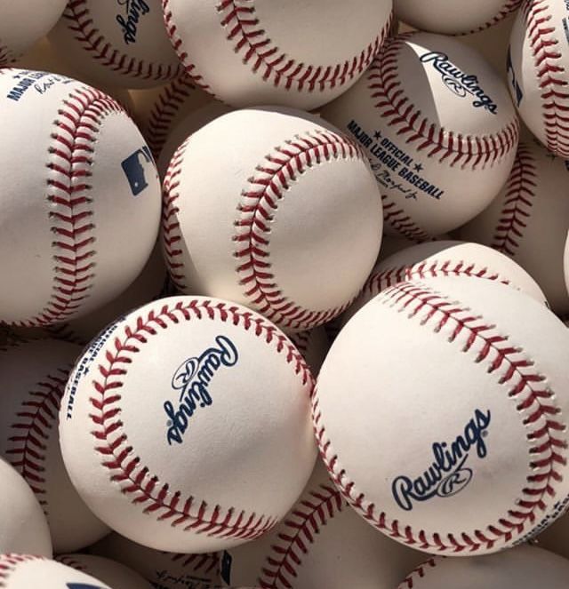 many white baseballs with blue lettering on them