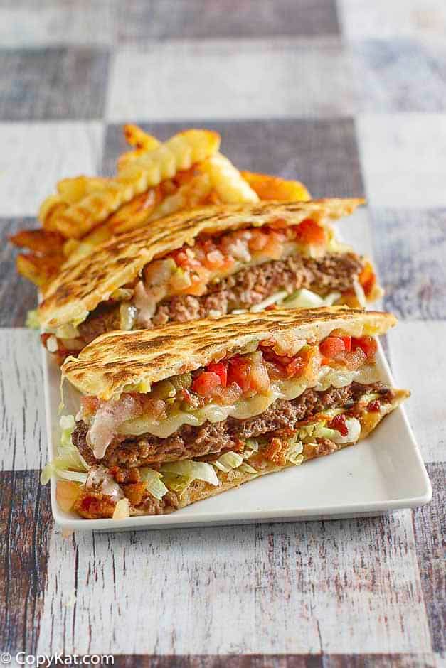 three quesadillas stacked on top of each other with chips in front of them