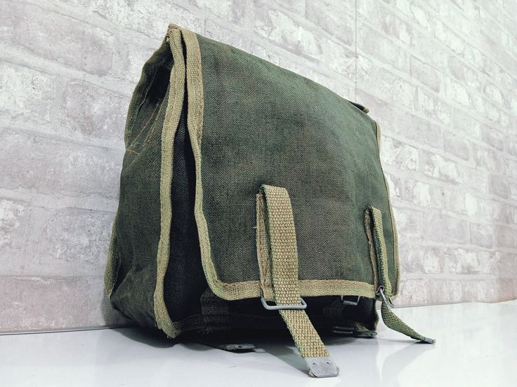 I offer you a military bag, the so-called military knapsack. Very compact bag that can be used to store a few smaller items. Used mostly in military by soldiers. This bag can be a great addition to your look or to an interior with military styled theme. Handy bag made of canvas material. Dimension: 25cm x25cm Width 10 cm Feel free to buy, we have large quantities It will be sent via registered and tracked courier. Please remember our items are vintage which means that they can have some imperfec Military Style Rectangular Travel Bag, Khaki Canvas Satchel For School, Military Style Khaki Bags For Travel, Military Style Khaki Travel Bag, Military-style Khaki Travel Bags, Practical Khaki Backpack, Rectangular Khaki Satchel For School, Outdoor Military Satchel Bag, Military Style Satchel Bag For Outdoor