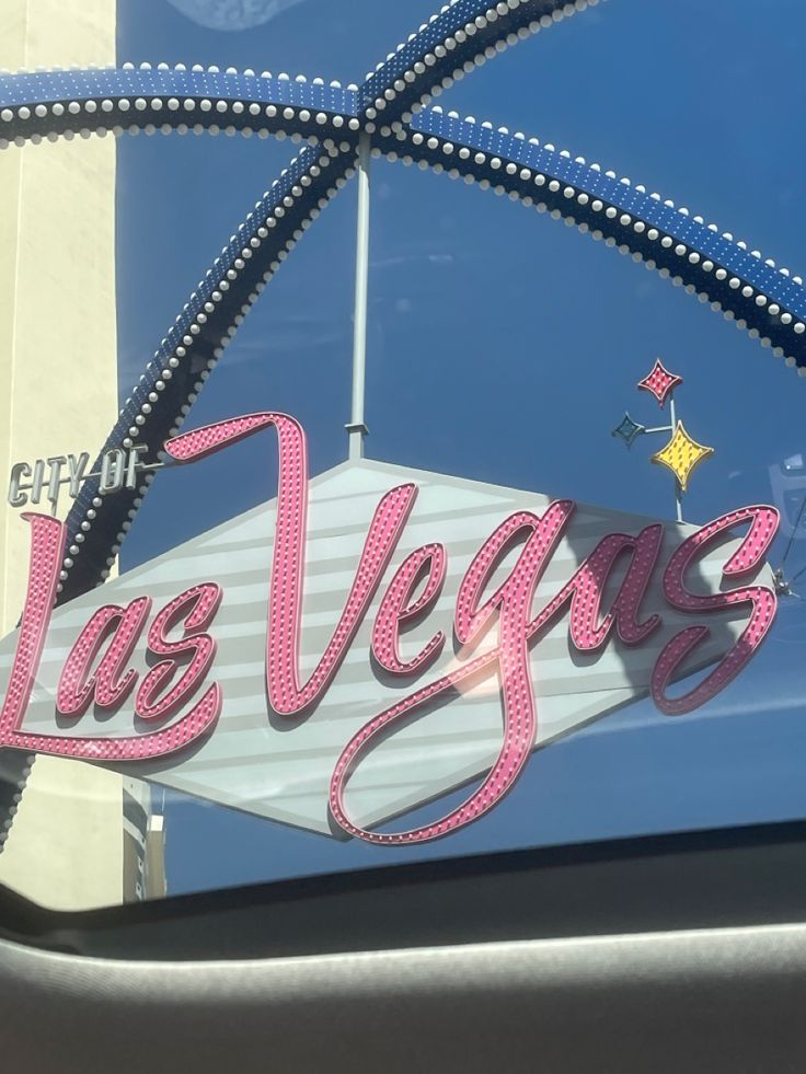 the las vegas sign is painted pink and silver