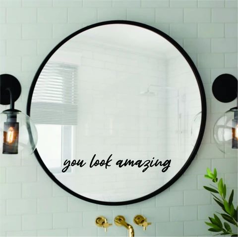 a bathroom mirror with the words you look amazing on it