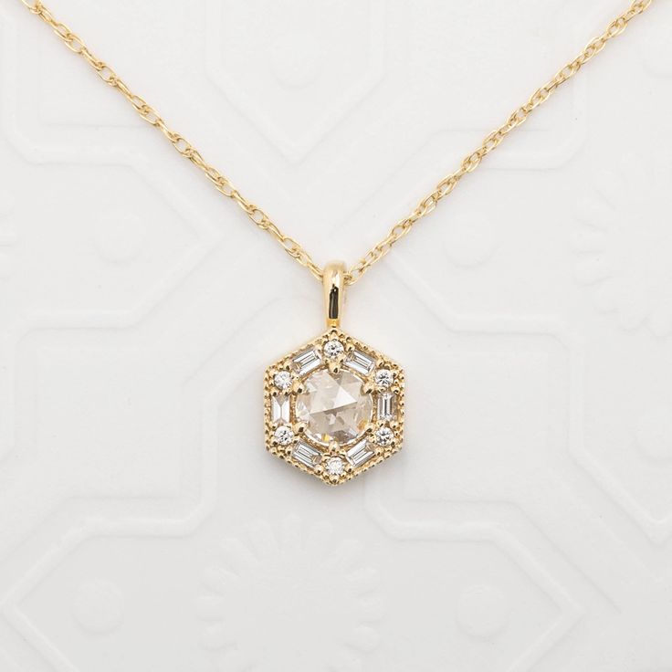 "Can be purchased as a pendant charm only or with rope chain necklace. Earth mined natural rose cut diamond necklace set in art deco inspired hexagon setting using baguette and round brilliant diamonds. Hexagon charm size: 9.5mm wide Approx. 0.14ct white accent diamonds Made of recyclable solid gold and ethically sourced gemstones If purchased as a necklace, comes with a rope chain with adjustable lengths at 18\" and 20\"." Luxury Teardrop Pendant Necklace With Rose Cut Diamonds, Art Deco Pendants, Rose Cut Diamond Pendant Jewelry, Octagon Diamond Necklace With Single Diamond, Gift Jewelry With Rose Cut Diamonds In Diamond White, Gift Jewelry With Diamond White Rose Cut Diamonds, Delicate Diamond White Jewelry With Rose Cut Diamonds, Elegant Hexagon Diamond Cut Necklace, Dainty Rose Cut Diamond Round Pendant Jewelry