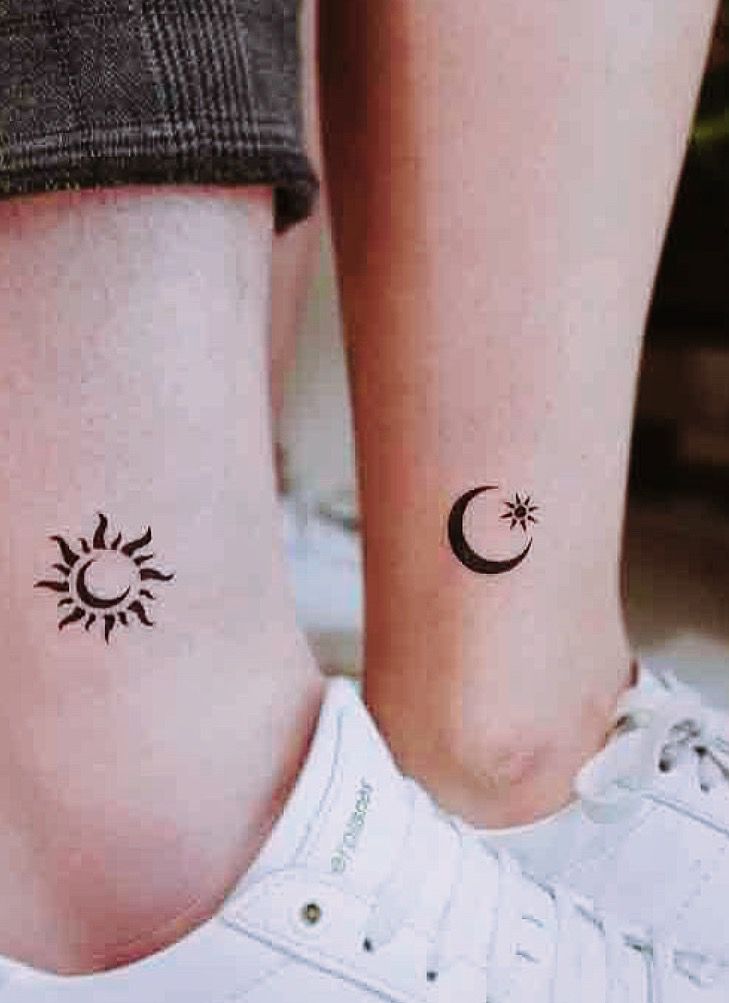 two small tattoos on the legs of people with sun and moon tattoo designs on them