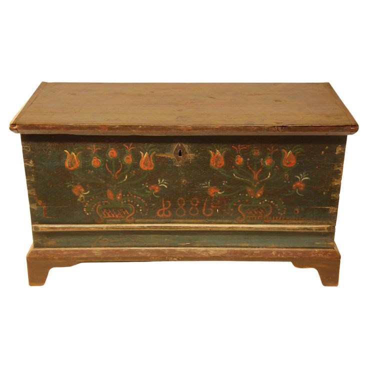 an old wooden box with painted designs on it