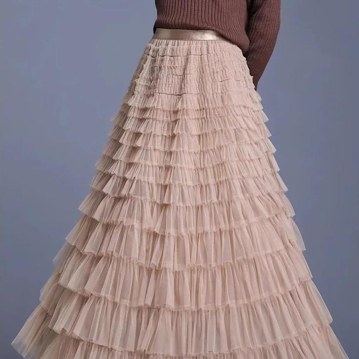 Discover the Charm of Elegance Step into a world of grace and style with our Elegant Spring/Summer Tulle Skirt. Designed for the modern woman who appreciates a blend of casual sophistication and timeless elegance, this skirt is perfect for a variety of occasions. Whether you're attending a casual gathering or dressing up for a more formal event, this skirt will elevate your wardrobe with its chic and versatile design. Product Features Material: High-quality polyester and voile blend for durability and a soft feel Style: Casual yet chic, with a solid pattern that pairs easily with any top Elasticity: Slight stretch to fit your body comfortably Season: Ideal for spring and summer wear Waistline: Empire cut to accentuate your figure Fit Type: Regular fit ensuring freedom of movement Silhouett Elegant Skirt With Ruffles, Elegant Tiered Maxi Skirt For Spring, Elegant Ruffled Maxi Skirt For Spring, Elegant Full Maxi Skirt For Spring, Beige Ruffled Skirt For Parties, Non-stretch Tiered Party Skirt, Non-stretch Tiered Skirt For Party, Elegant Beige Gathered Maxi Skirt, Elegant Spring Tiered Skirt