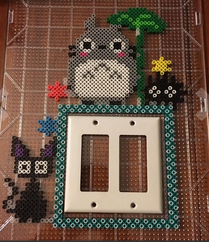 a cross stitch picture frame with animals on it