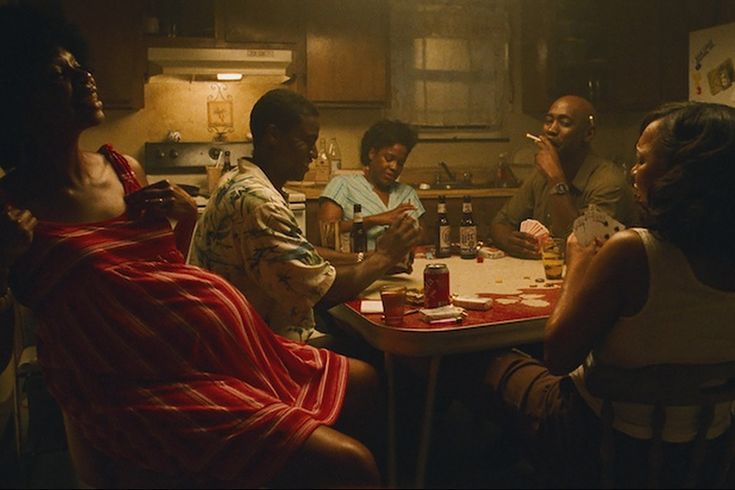 a group of people sitting around a kitchen table