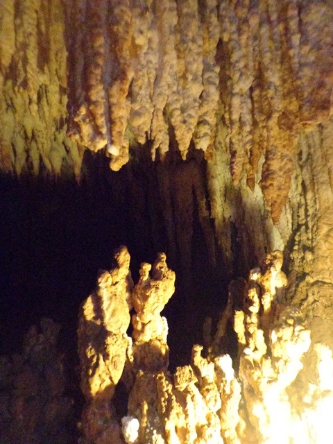 the light is shining on some rocks in the cave, and it looks like they have been carved into something