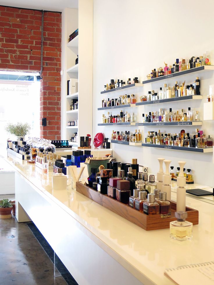 the shelves are filled with different types of perfumes and other personal care products on display