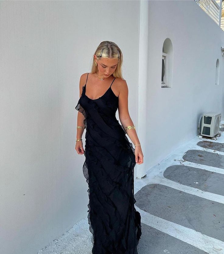 Step into a world of whimsical charm with our ruffle maxi dress, where glamour meets graceful movement. This dress features enchanting cascading ruffles that dance with each step you take. Designed to drape elegantly to the floor, it boasts an alluring scoop open back and a delicately low-cut bust, adding a touch of sultriness. The adjustable spaghetti straps allow for a custom fit, while the soft, floaty chiffon fabric provides an ethereal feel. Enhanced with exquisite ruffle detailing and fully lined for comfort, this maxi dress is a stunning choice for any occasion that calls for a touch of elegance.   Material: Chiffon - polyester, spandex blend. Rat And Boa Selena Dress, Selena Dress, Selena Dresses, Ruffled Silk Dress, Rat And Boa, Ruffle Maxi Dress, Cascading Ruffles, Tulle Ball Gown, Ball Gowns Evening