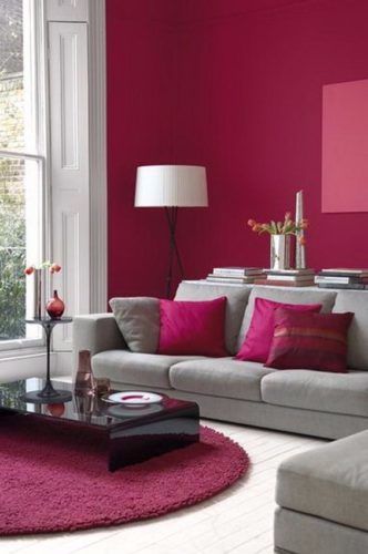 a living room with pink walls and white furniture in the center, along with a red rug on the floor