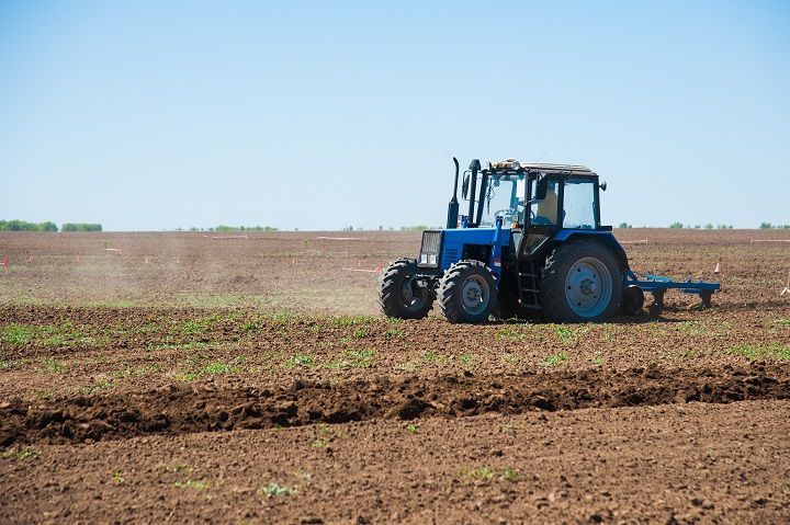 a tractor is plowing the field with dirt