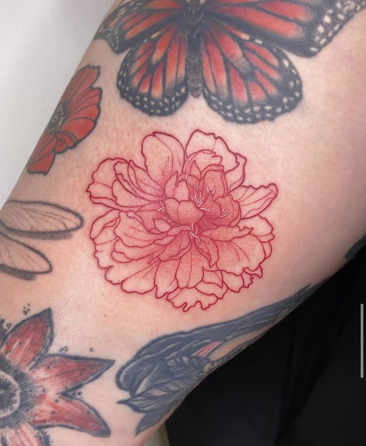 a woman's arm with butterflies and flowers on it