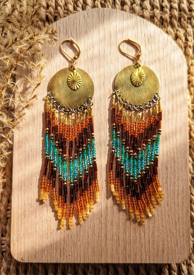 Beaded native earrings handmade with glass beads, brass, hematite, and gold plated leverbacks. Stone: 18k gold plated hematite Beads: Czech Leverbacks: 18k gold plated brass Drop Height: 4.5 in. Nickel Free Aisholpan is the first girl to win the male-dominated Eagle Hunter Competition in Mongolia. Beaded Earrings Native Beadwork Moon & Milk, Artisan Multicolor Beaded Earrings With Gold Beads, Bohemian Gold Earrings With Beaded Chain, Gold Artisan Beaded Earrings With Dangling Beads, Bohemian Gold Beaded Earrings With Czech Glass, Artisan Gold Beaded Earrings, Artisan Earrings With Gold Beads, Traditional Gold Beaded Earrings With Colorful Beads, Traditional Gold Beaded Earrings With Tiny Beads