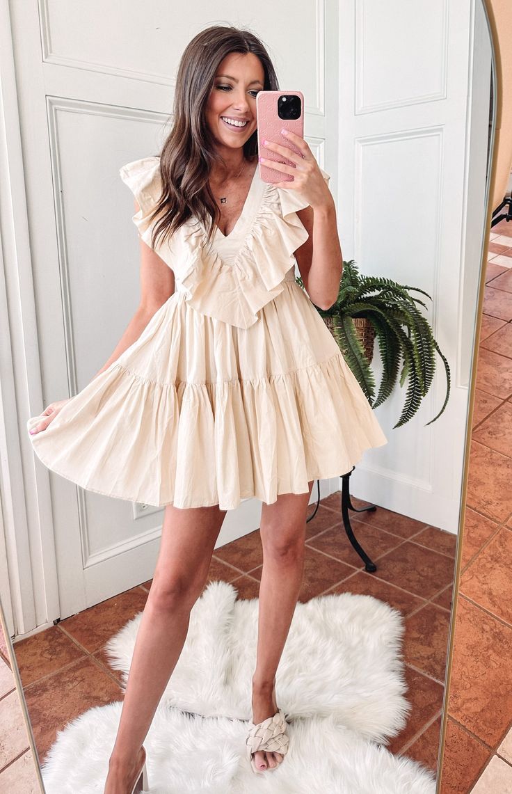 - 100% Cotton - True to size - Model is pictured in a size small - Adjustable ties along the back Be the life of the party with our Laurel Beige Dress! This comfy cutie is made of cotton and has beautiful beige coloring with frilly ruffles that will make heads turn. Look good, feel good—we got you, babe! (You can even pair it with some white sneakers for a more casual look!) Cream Cotton V-neck Mini Dress, Beige Summer Dress With Ruffled Straps, Cute Beige Mini Length Dress, Cotton Ruffle Dress For Garden Party, Cotton Mini Dress With Ruffle Hem For Brunch, Cotton Tiered Mini Dress For Garden Party, Tiered Cotton Mini Dress For Garden Party, Cute Beige Mini Dress For Summer, Cream Cotton Dress For Garden Party