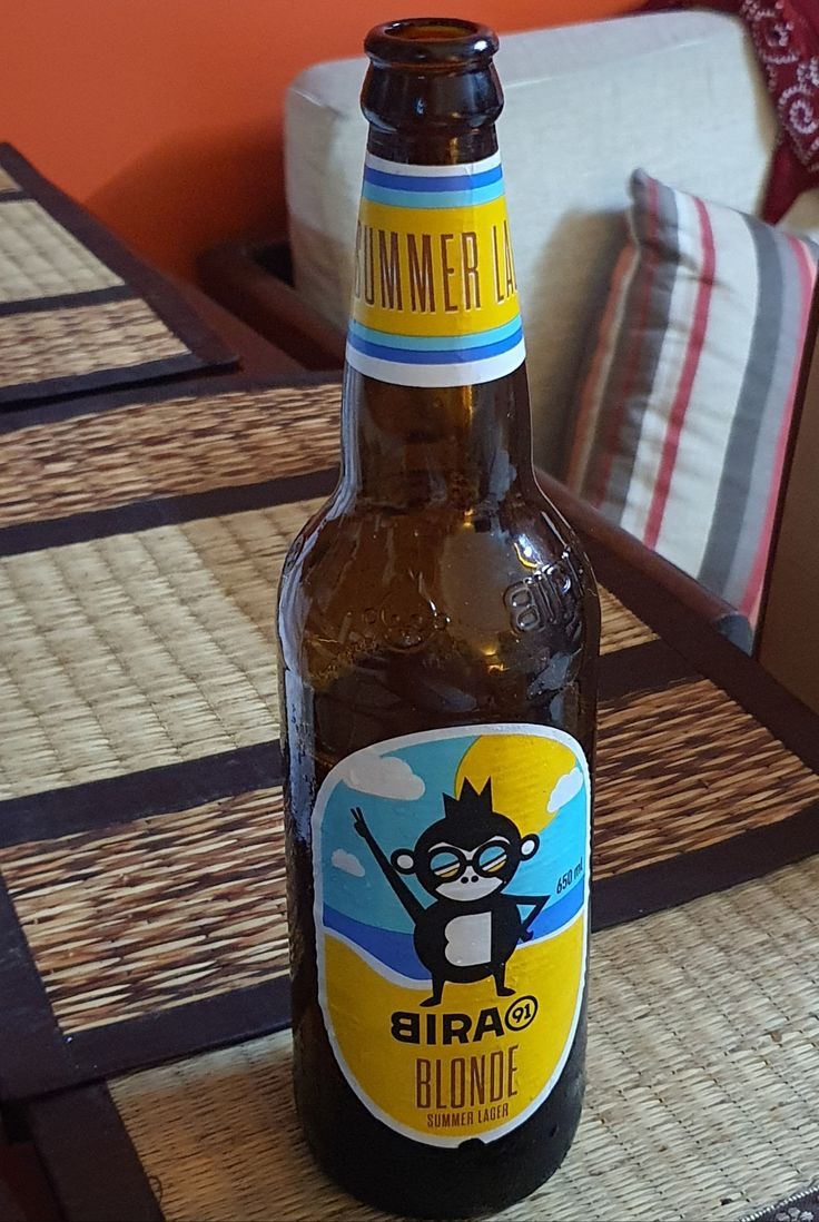 a beer bottle sitting on top of a wooden table