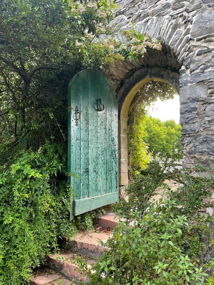 an open door in the side of a stone building with steps leading up to it