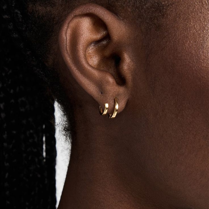 Katerina Double hoop earring, featuring the versatility of a two hole piercing, without the piercing. One larger hoop fits comfortably into a piercing, whilst the smaller accompanying hoop works as an adjustable ear cuff, sold as a pair. 18ct Vermeil Gold on Sterling Silver Measurement: Smaller hoop 0.39"(10mm) / Larger hoop 0.5"(13mm) Everyday Small Hoop Ear Cuff Single Earring, Everyday Small Hoop Pierced Ear Cuff, Small Hoop Single Earring For Everyday Wear, Tarnish Resistant Huggie Ear Cuff, Classic Hoop Piercings, Tarnish Resistant, Everyday Small Hoop Ear Cuff, Classic Tarnish Resistant Hoop Piercings, Classic Tarnish-resistant Hoop Piercings, Adjustable Small Hoop Wrap Earrings