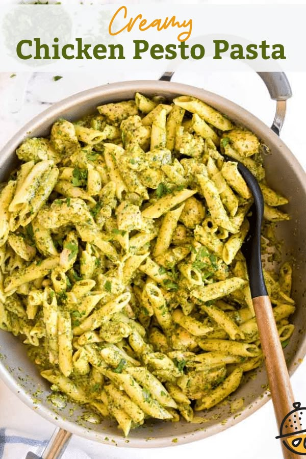 a pan filled with pesto pasta on top of a table