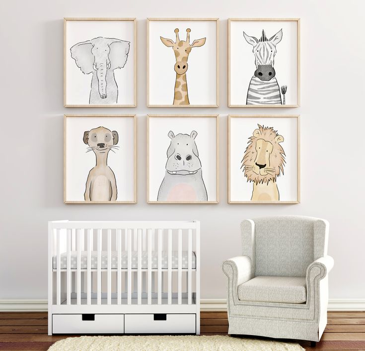 a baby's room with four animal prints on the wall