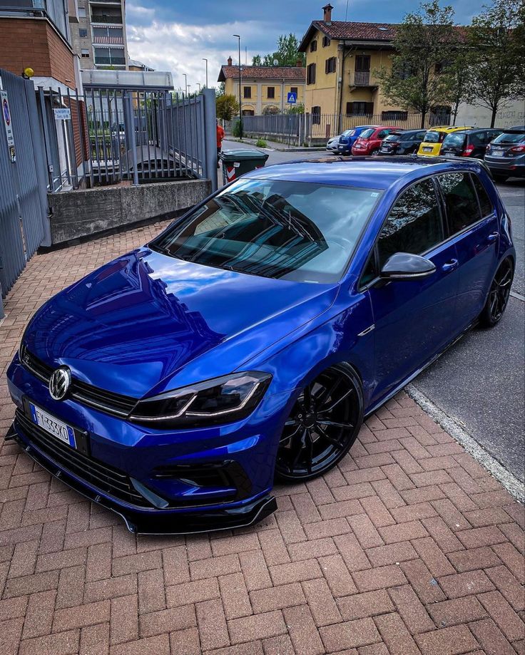 a blue car parked on the side of a road